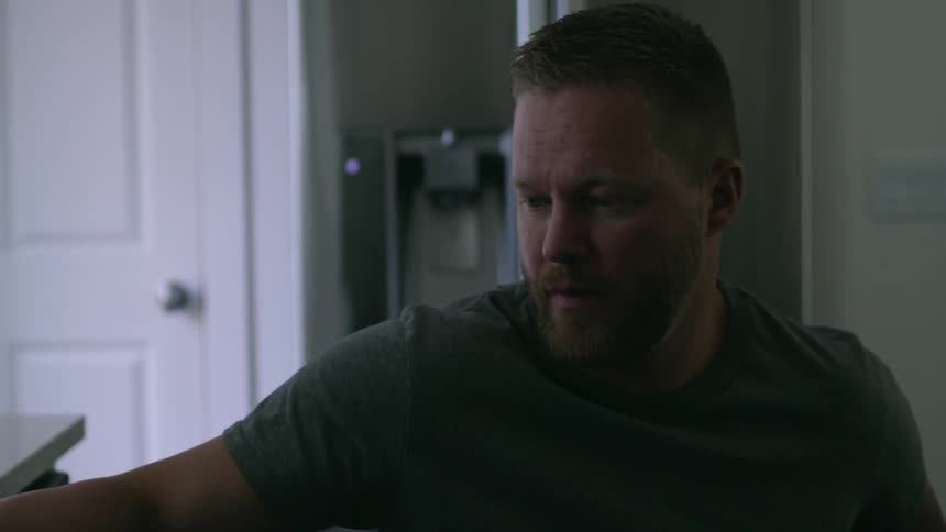 Man in wheelchair rolls into kitchen