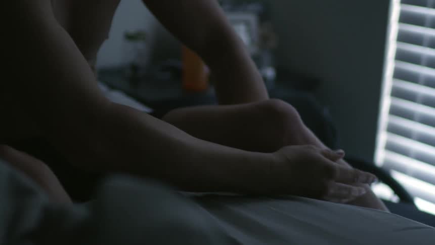 A paralyzed man is adjusting his legs to get out of bed