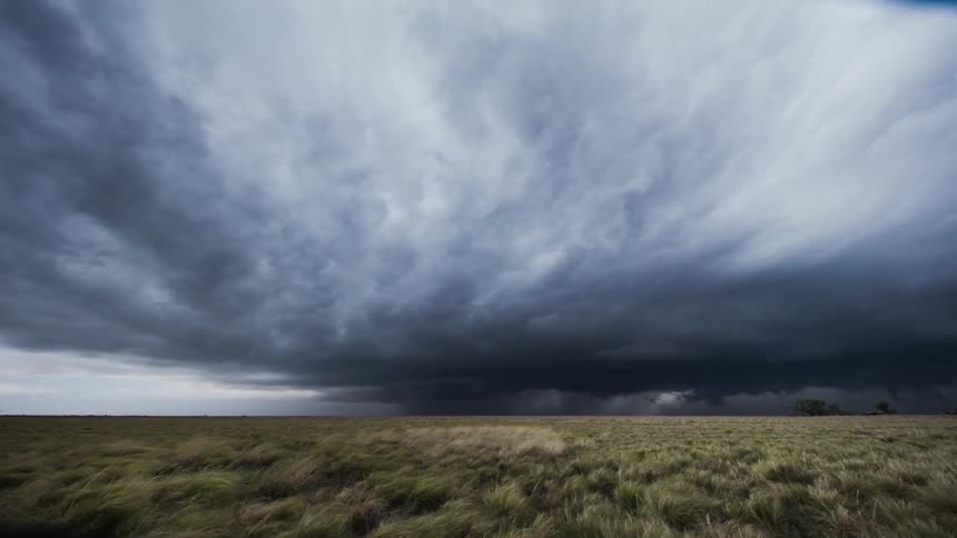 The storm clouds move fast over the field