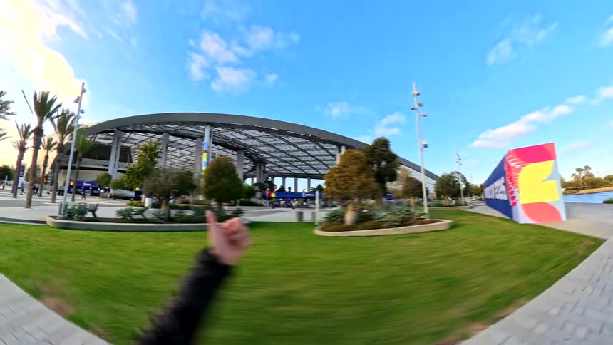 A dynamic point-of-view walkthrough of SoFi Stadium, passing security and FIFA World Cup 2026 branding before revealing the crowded interior during a match