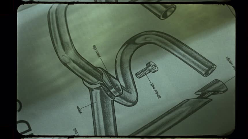 Close-up shots of a bicycle repair manual's technical illustrations are shown with an old film effect