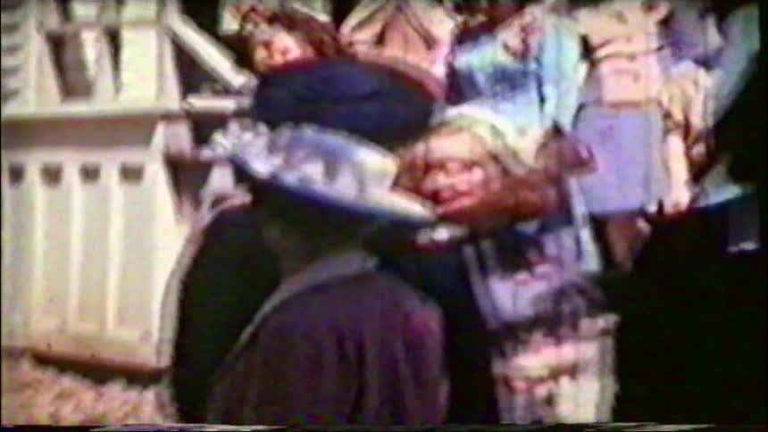 Vintage footage from the 1940s shows a group of well-dressed women in hats and dresses mingling on the steps of a building after a social event