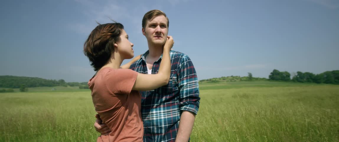 Man and woman hugging in the middle of a field