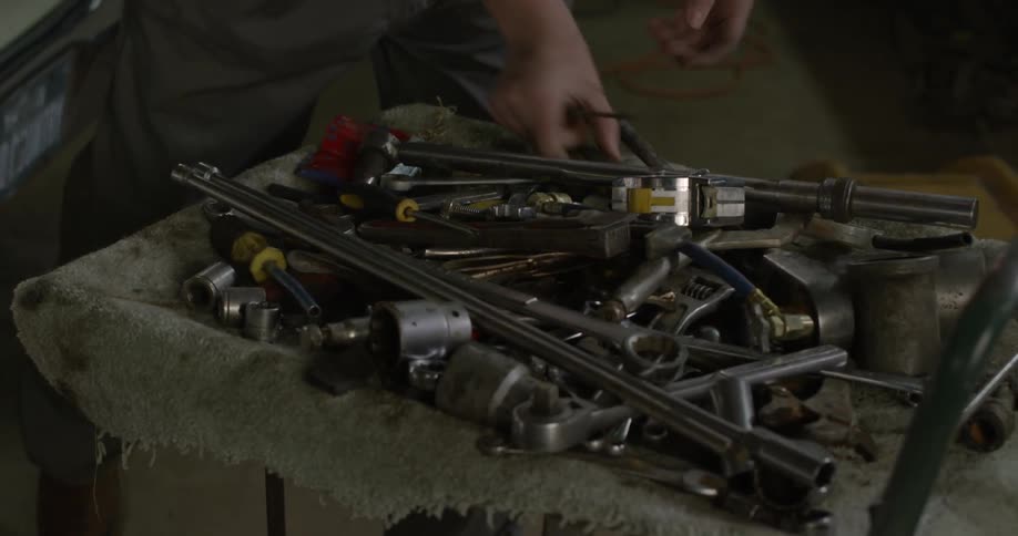 A mechanic works on a car