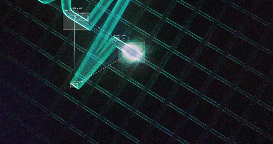 A glowing light source is tracked with data overlays as it moves across a dark digital grid background