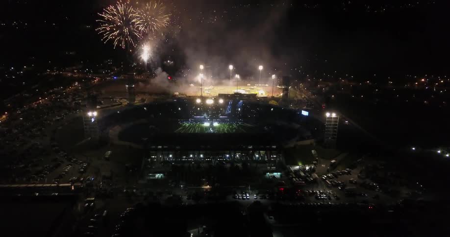 Fireworks explode over a stadium at night