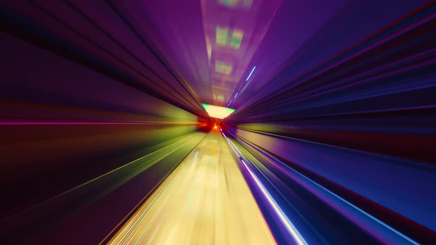 Futuristic hyper-lapse from the front of a subway train as it speeds through a tunnel, creating vibrant, abstract light streaks