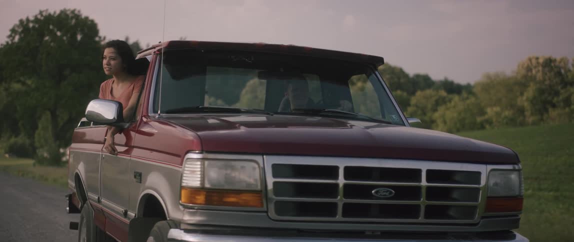 Man and woman ride in a pickup truck