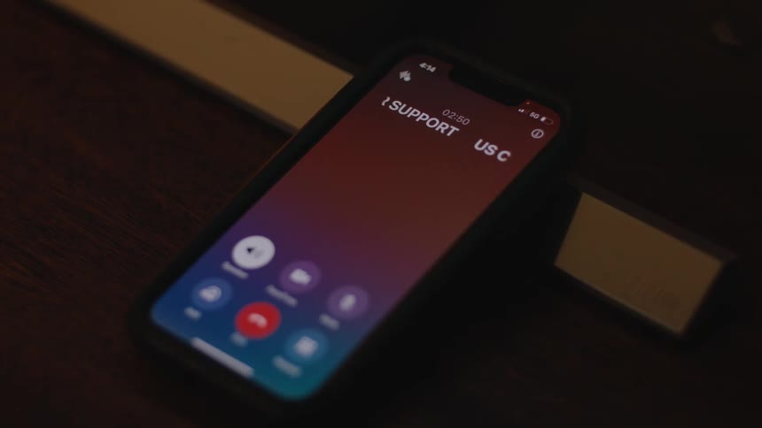 A smartphone screen displays an animated caller ID for 'US Customer Support' during an active call