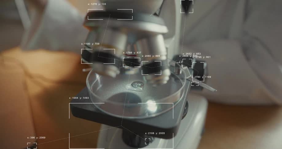 A scientist places a sample in a petri dish under a microscope with an advanced digital analysis interface