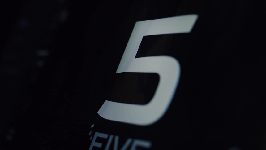 A sleek, modern digital timer counts down from ten to zero on a black screen