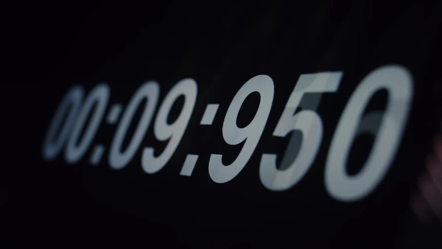 Macro shot of a stopwatch timer counting up from zero on a black background