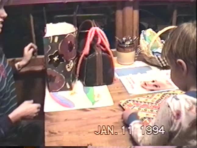 Vintage VHS footage from January 1994 shows a mother giving her young son a large present at their home