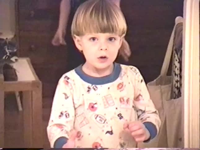 Vintage VHS footage shows a little boy in pajamas playing and throwing a ball inside his home