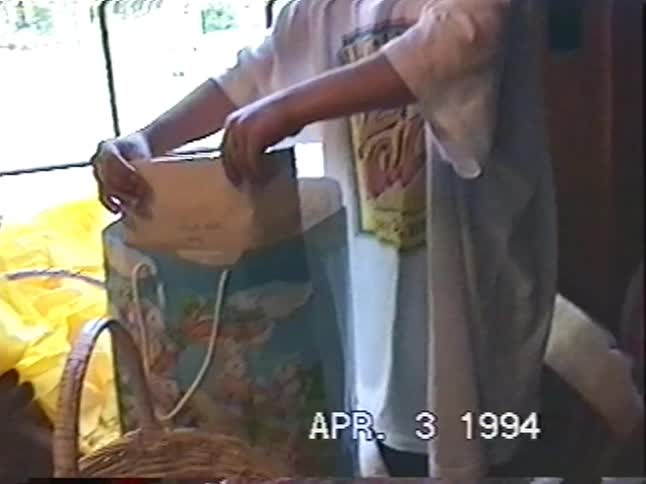 An excited young boy receives a stuffed animal from an Easter gift bag in this nostalgic home video from 1994