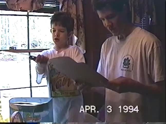 A vintage home video from Easter 1994 shows two young brothers sharing a moment of excitement over their gifts