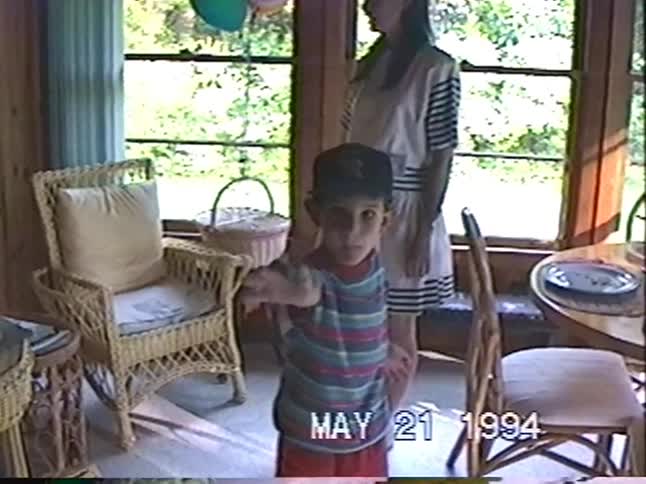 Vintage 1994 home video shows a young boy and his mother celebrating a birthday with balloons in a sunlit room
