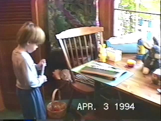 A cute little boy with a bowl haircut excitedly talks to the camera on Easter morning in a home video from 1994