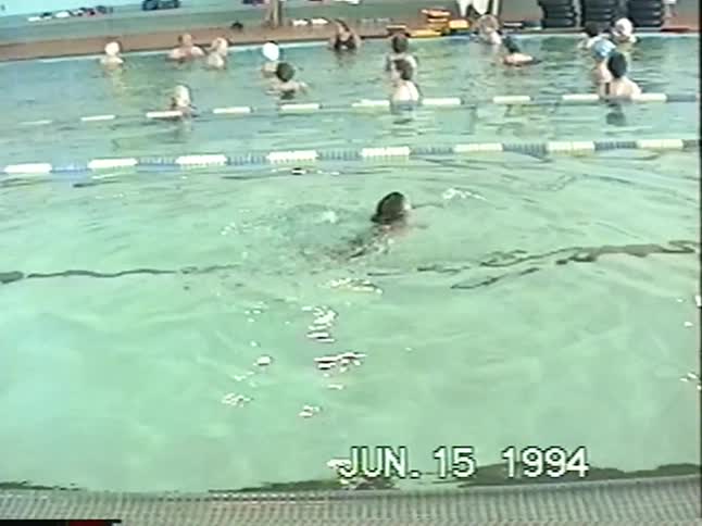 A vintage home video from 1994 shows two young boys practicing their backstroke and floating in an indoor swimming pool during a class