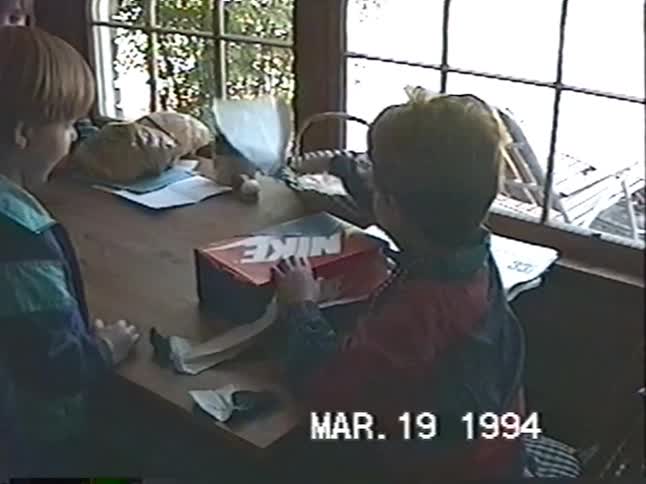 A nostalgic home video from 1994 shows a young boy happily unboxing a new pair of Nike sneakers for his birthday