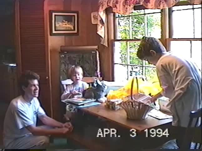 A family with two children celebrates Easter morning, discovering their baskets and a real live bunny in this 1990s home video