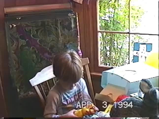 A vintage home video from 1994 shows a young boy excitedly discovering his Easter basket full of toys and candy