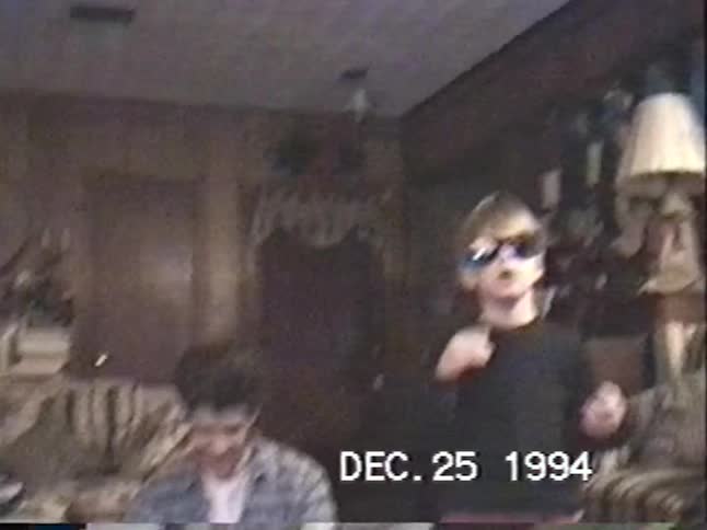 A vintage home video from Christmas morning in 1994 shows two young brothers opening presents with their dad