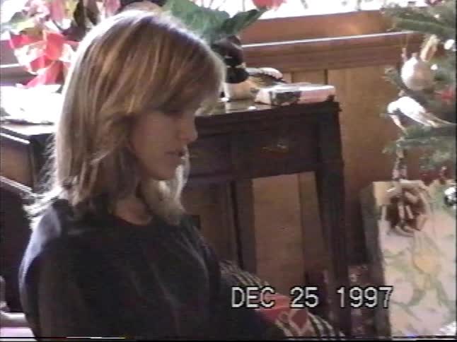 A mother opens a new atlas with her son on Christmas morning in this authentic 1997 home video