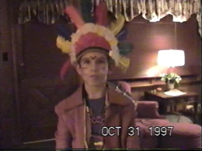 A vintage 1997 VHS clip shows a young boy dressed in a Native American chief costume for Halloween