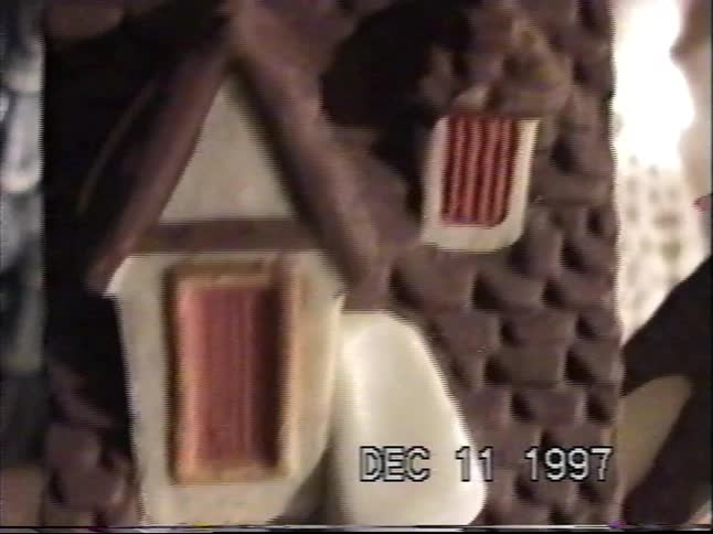 Vintage VHS footage from 1997 pans across a miniature Dickensian Christmas village scene