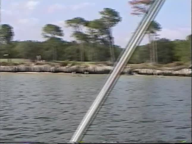 Vintage home movie from 1997 shows a man and a young boy enjoying a sunny day of fishing from a boat on a calm bay