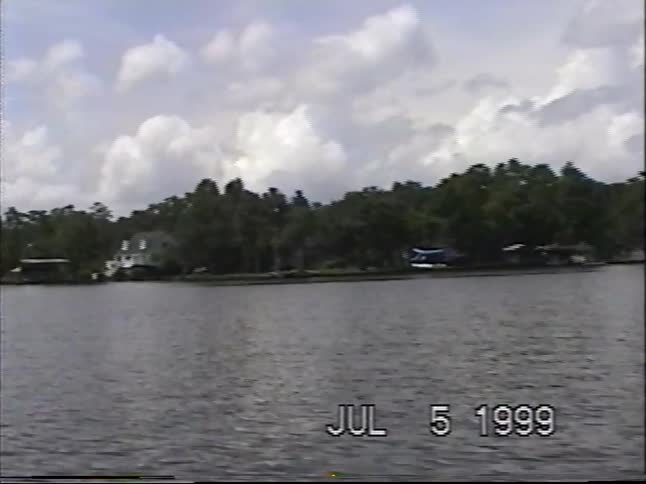 Vintage 1999 VHS footage shows a seaplane landing gracefully on a calm lake