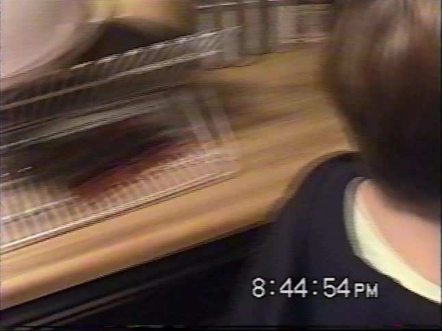 Vintage footage shows two young boys excitedly sorting through their massive haul of holiday candy in the kitchen