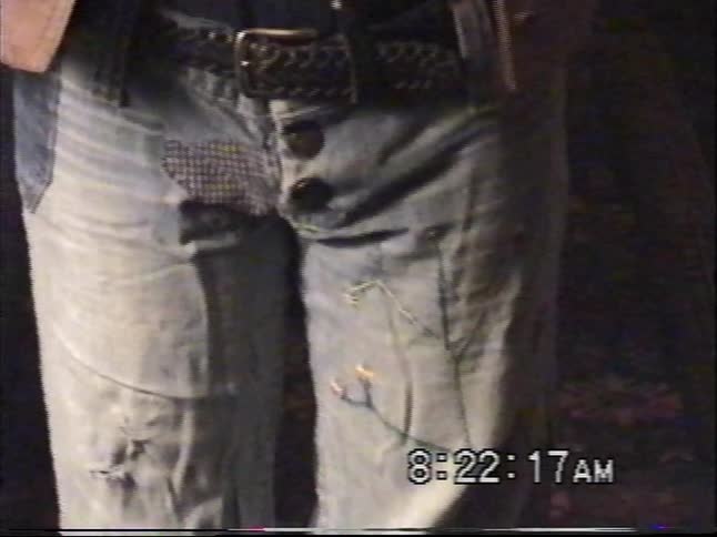 A young boy with a unique sense of style proudly models his eclectic 90s outfit for the home video camera in 1999