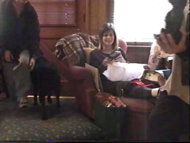Vintage home video captures a happy boy showing off his new dog figurine gift that looks just like his real black lab