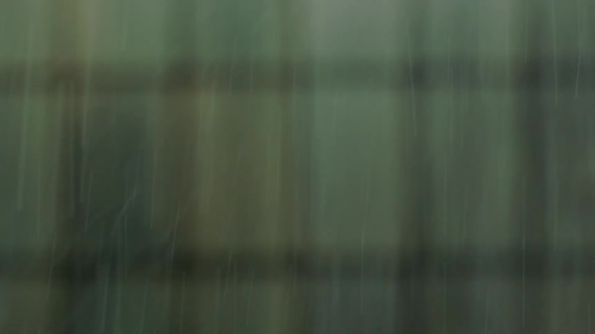 A heavy rain and sleet storm falls against an abstract out-of-focus background