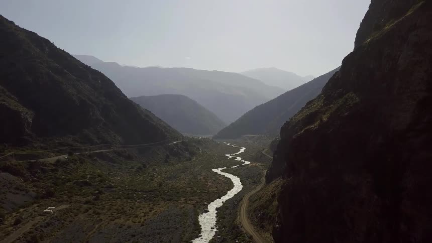 A small stream runs between these mountains