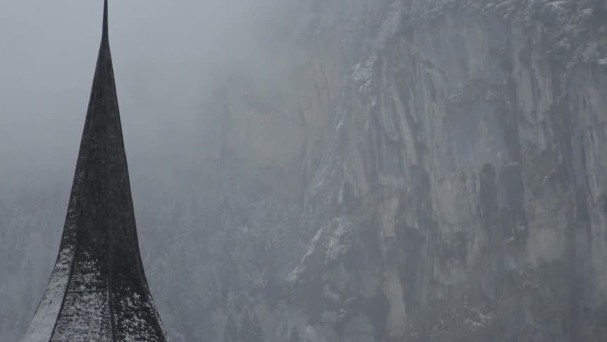 Cross upon a spire on a snowy day