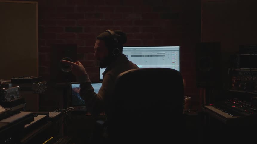 A man talks while working on a computer