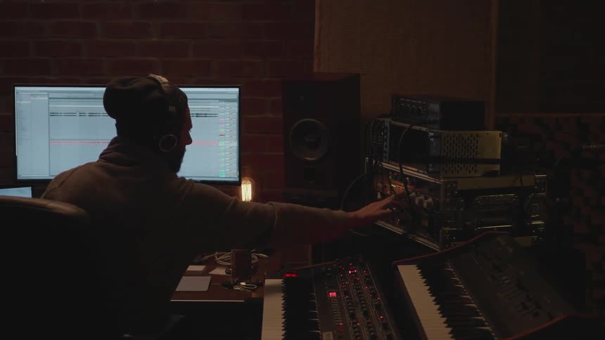 A man is working in a music studio
