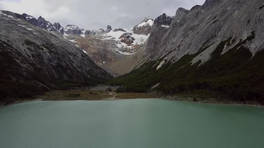 Lake surrounded by mountains on a cloudy day