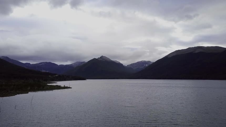 A lack surrounded by mountains on a cloudy day