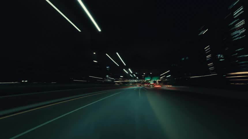 An exhilarating POV time-lapse speeds through a futuristic urban tunnel at night, with lights blurring into streaks of motion