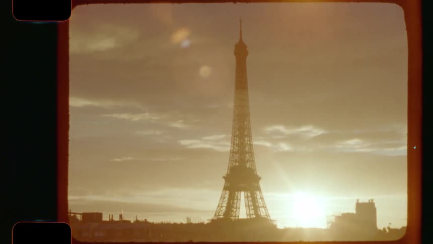 A vintage 16mm film style shot shows the iconic Eiffel Tower in Paris silhouetted against a golden sunrise