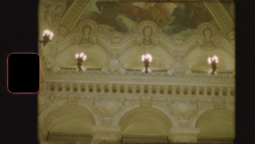 Vintage 8mm footage reveals the ornate architecture and magnificent painted ceiling of a grand opera house in Europe