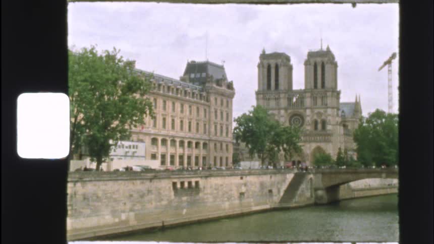 Authentic vintage film captures a scenic view of Notre Dame Cathedral and the River Seine in Paris