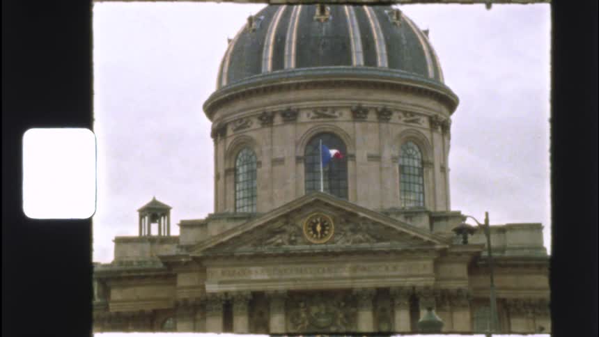 A vintage film shot captures the grand facade of the Institut de France in Paris with the French flag waving