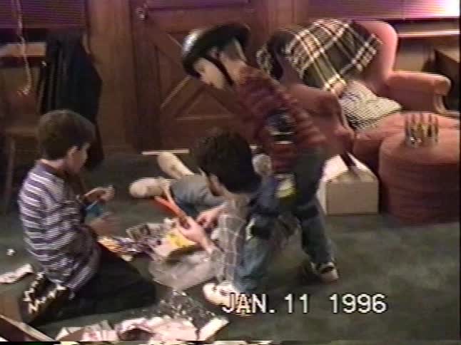 A home video from 1996 shows several young boys in a living room opening presents and playing with new toys