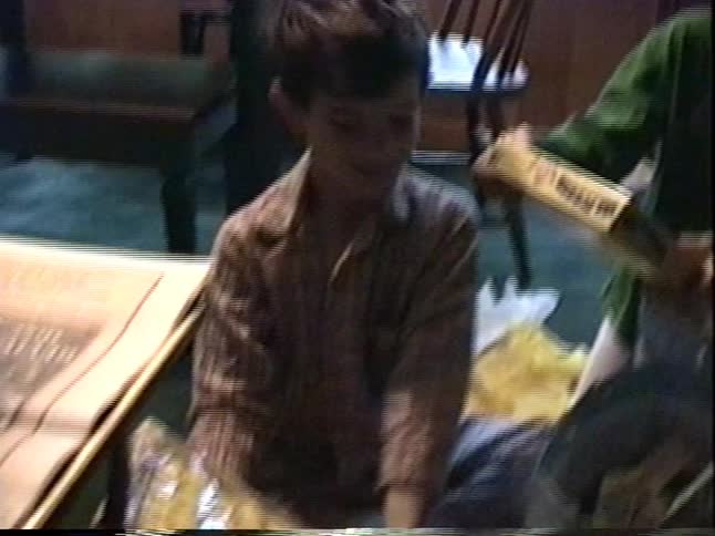 Two young boys in pajamas excitedly look through their Easter gift bags on a holiday morning