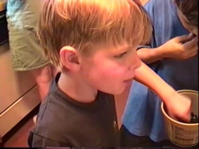 Children help prepare a homemade blackberry pie together in a warm family kitchen